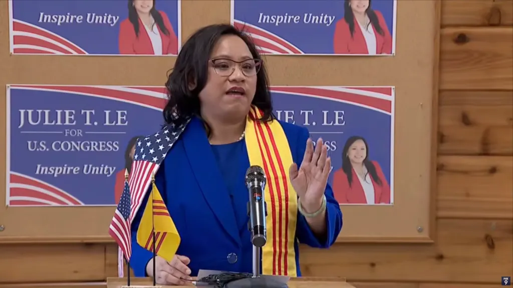 Julie T. Le campaigning for U.S. Congress, with banners reading 